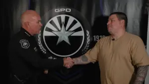 Bryan Peters shaking hands with the police chief.