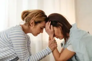 A woman comforting a loved one with depression