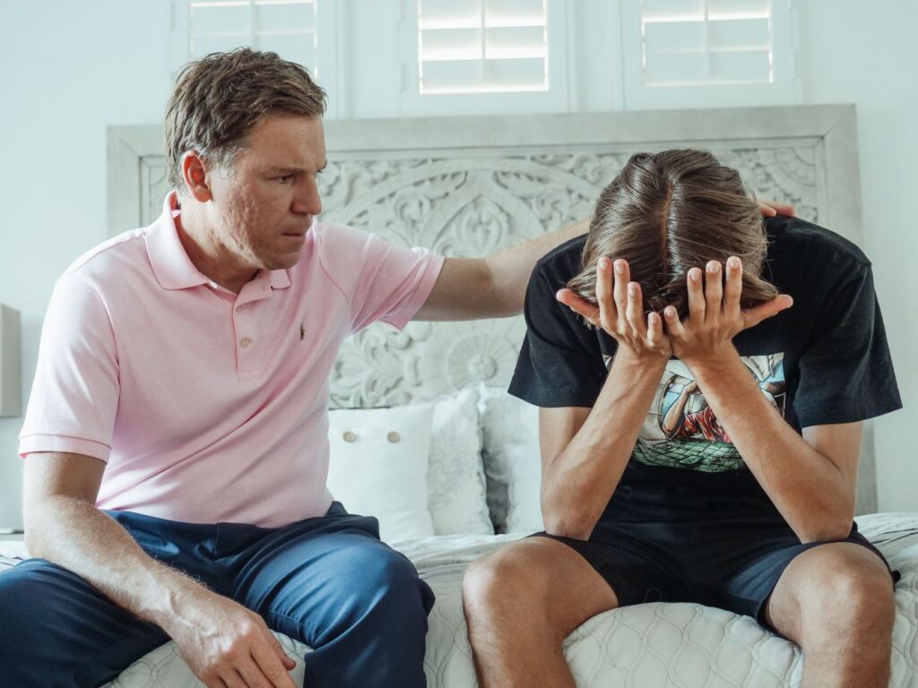 A father comforting his son