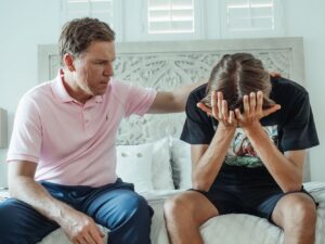 A father comforting his son