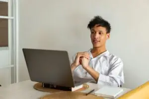 Man sitting at his laptop attending an online intensive outpatient program