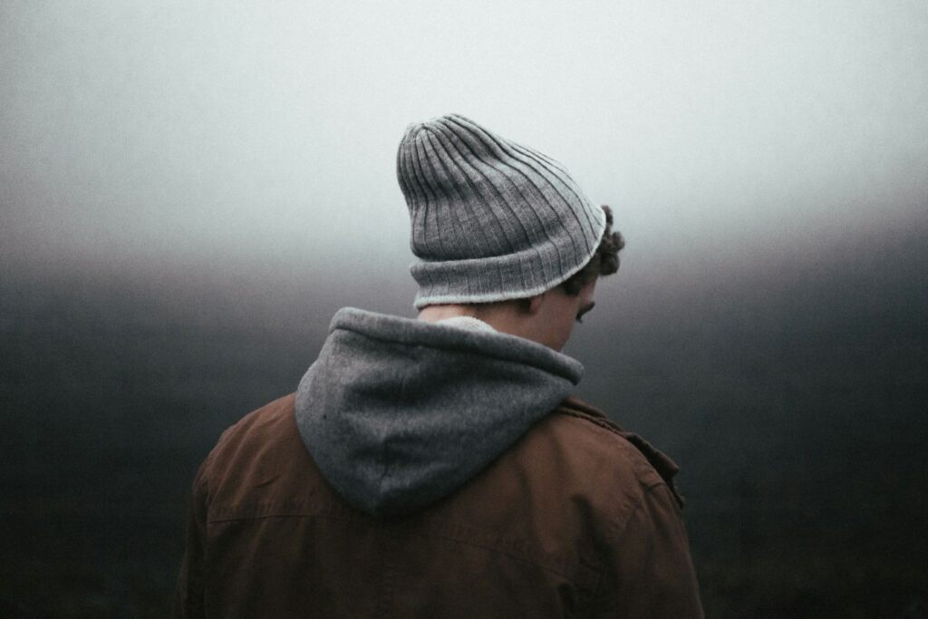 Moody teenager wearing a beanie hat
