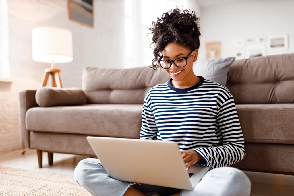 woman sitting on the floor of her living room participating in virtual iop